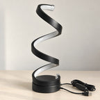 Svart spirallampa LED med USB-sladd och dimmer på ljust bord